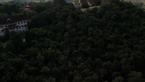 Beautiful cinematic tilt up reveal of Temple on top of hill with landscape in distance