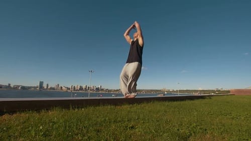 Young Man Performs Acrobatic Flip on the Edge of a