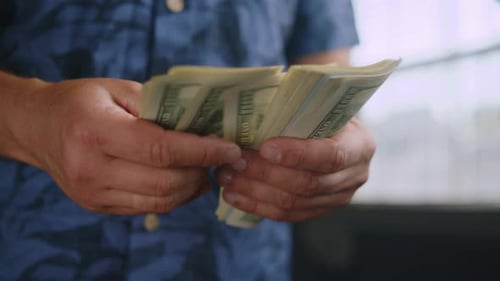 Man Counting Money Indoors Close Up