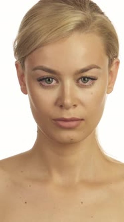Young Woman Looks at Camera in Studio Close-Up