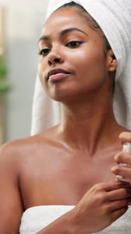 Woman Applies Spray in Bathroom After Shower