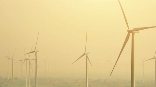Vast wind farm with numerous turbines standing tall, aerial view drone.