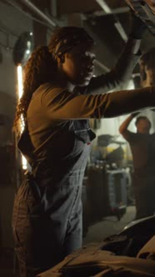 Black Woman Repairing Car