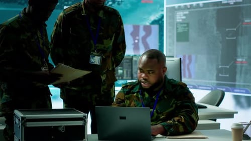 Military Personnel in a Modern Command Center Handle Critical Information
