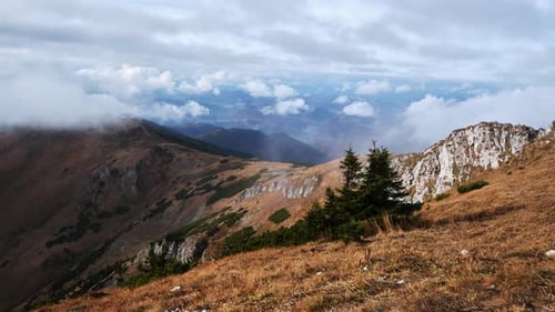 Timelapse Clouds Over Rocky Mountain Landscape with Pine Trees