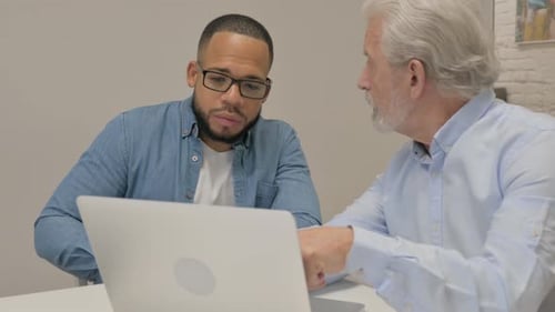 Businessman Talking with Male Worker in Office