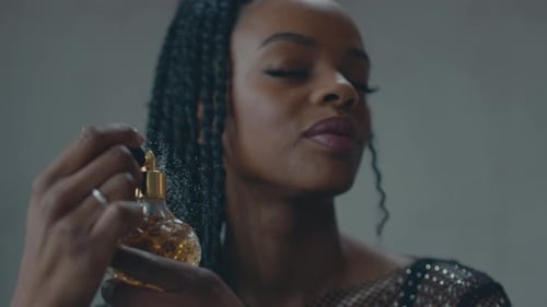 Woman sprays perfume in close up view