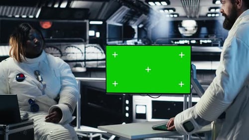 Researchers Flying Together in Starship Looking at Green Screen Monitor