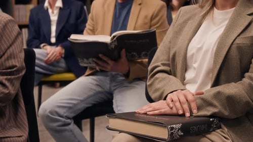 Group of Unrecognizable People Holding Same Book During Book Club