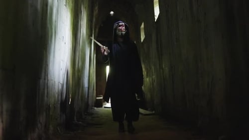 Man In Demon Mask Walking In Ruins