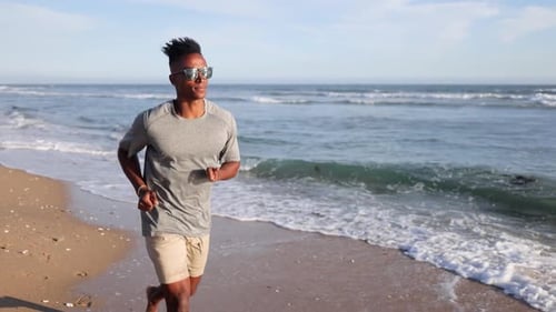 African American Man Walking At The Beach