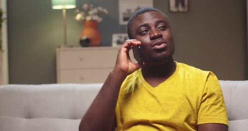 Man Conversing on Cell Phone Indoors