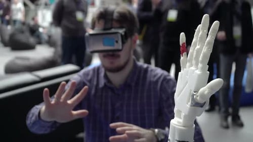Man demonstrates futuristic cybernetic arm technology in virtual reality