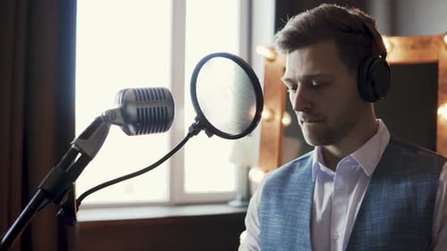 Man Recording Music in Professional Studio