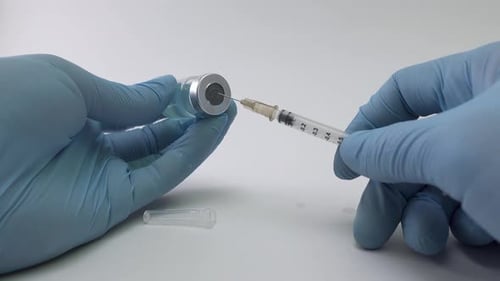 Preparing Injection: Filling Syringe from Vial in Gloves