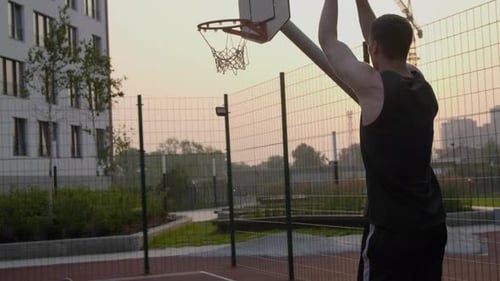 Male Athletic Teenager Score a Goal Playing Basketball at Evening City Court