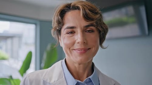Smiling Doctor Looking Camera Confidently Standing in Healthcare Clinic Closeup