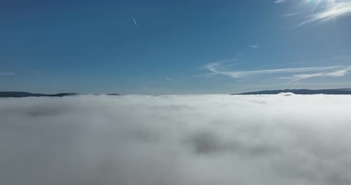 Drone Flight Over the Clouds During Sunrise