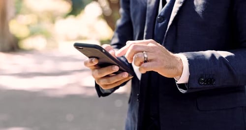 Cellphone, hands and closeup of man in a park typing a text message or networking on social media