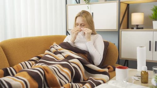 Young sick woman runny nose.