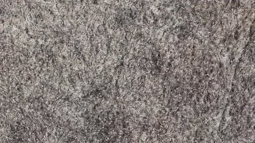 A close-up shows the intricate texture of dense, grey fibrous material, suitable as a versatile