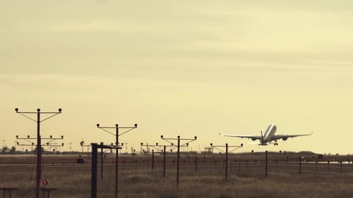 Airplane Taking Off on Runway at Sunset