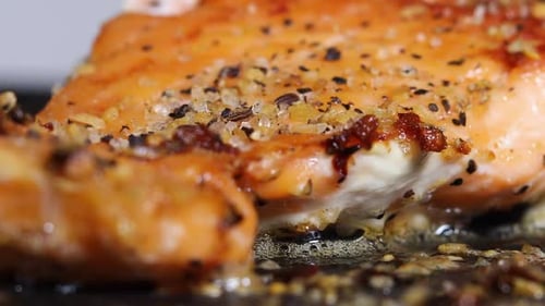 Sizzling Seasoned Salmon Fillet Cooking Close Up with Melted Butter