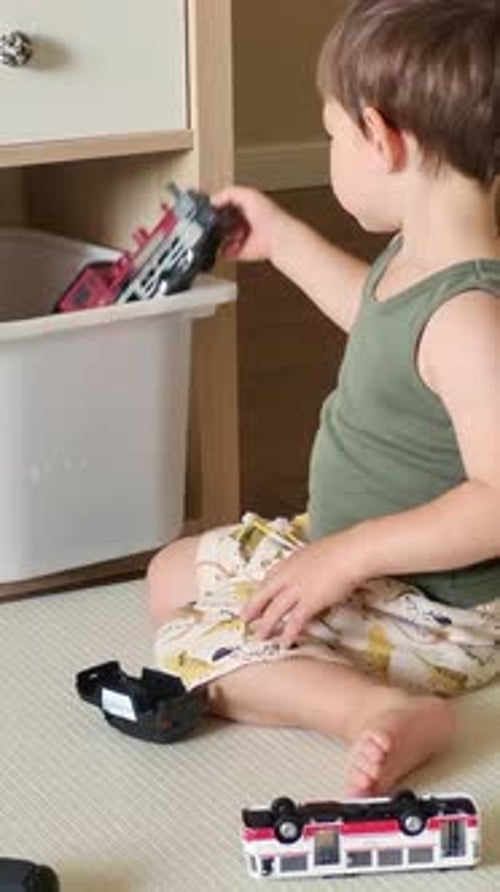 Brown Haired Child Plays With Toys Indoors