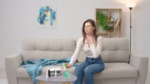 Woman Uses Inhaler for Respiratory Treatment at Home