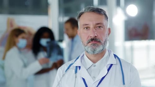 Handsome Mature Caucasian Man Doctor Portrait in Medical Office Face of Professional Chief Therapist