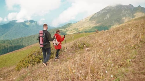 Tourists Climbing Mountain in Weekend Trip Man and Woman Walking on Mount Slope