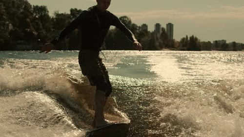 Wake Surfer Enjoy Evening Waves. Close Up of Rider Surfing Waves At