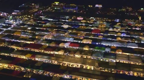 Aerial Panning of Colorful Asian Market Tents and Food Stalls at Night