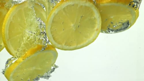 Lemon Slices Falling into Water, Bubbles