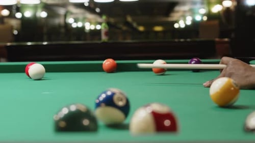Snooker Player Striking Cue Ball in Club