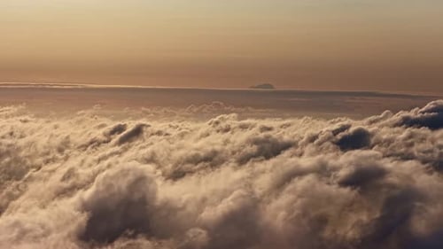 Flying Above Golden Clouds at Sunset