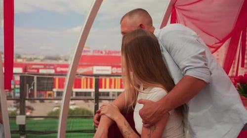 Couple Sharing Sunset on Rooftop Intimate Couple Enjoying Evening City View Tender Moment Captured