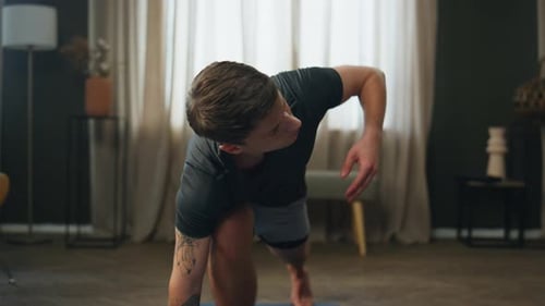 Man Stretching Body Home on Fitness Mat Close Up