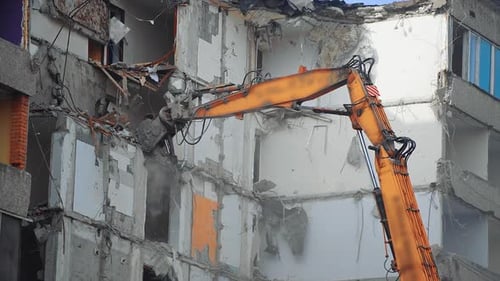 Special machine destroys the house. Demolition excavator destroys an old building