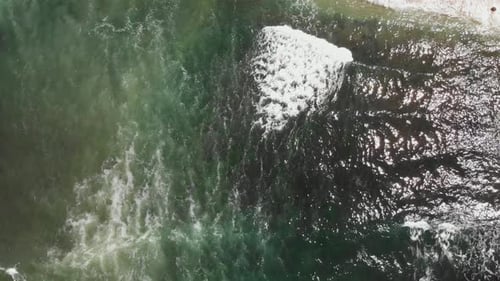 Expansive aerial pan up and out over the Pacific Ocean in San Diego, California.