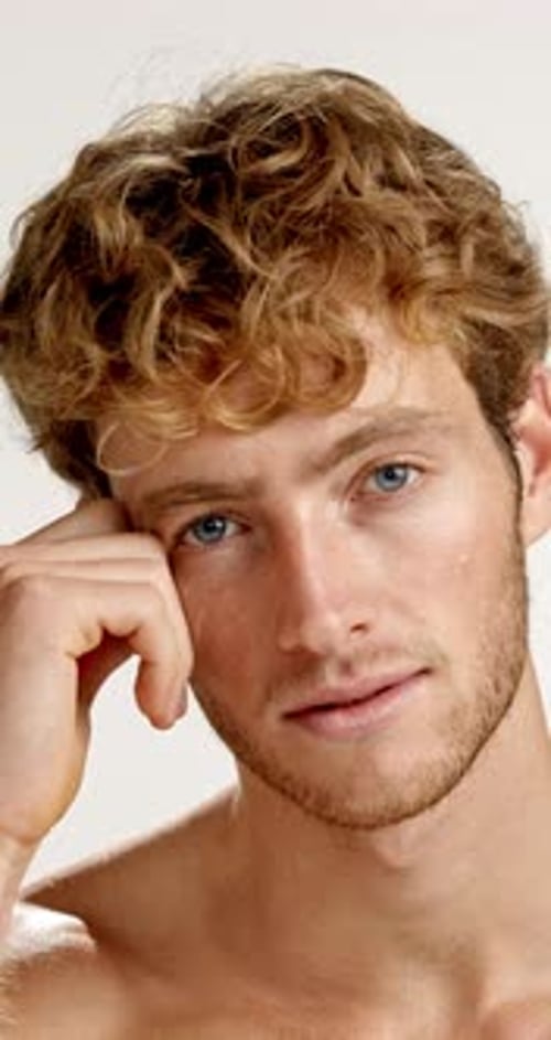 Face, beauty and confident man in studio for skincare, self care and grooming on white background