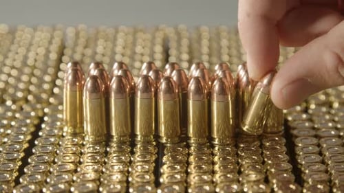 Hand Places Gold Bullet in Array