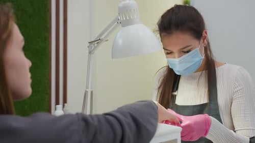 Nail Technician Giving Manicure in Salon