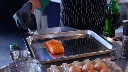 Chefs Preparing Salmon with Oil and Salt