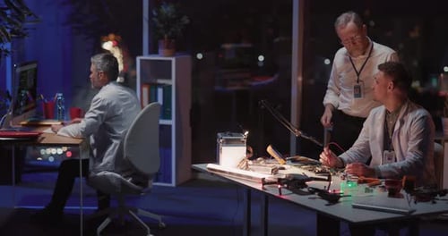 Multigeneration Facility Office Working at Night Repairman Soldering Iron Fixing Materials While His