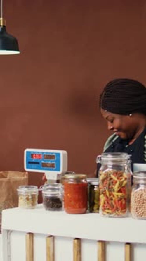 Vertical Video Shopper Choosing Pasta and Spices Stored in Jars
