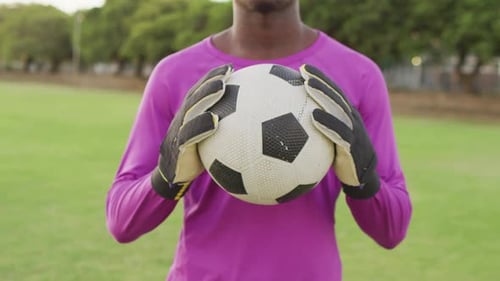 Video of african american football player on field with ball