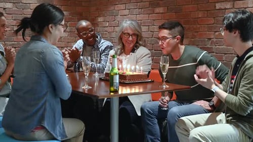 Creative Business People Celebrating Birthday With Cake And Champagne In Office