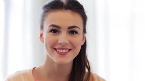 Attractive woman smiling broadly in a well-lit room