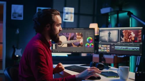 Man Editing Video at Computer Workstation at Night
